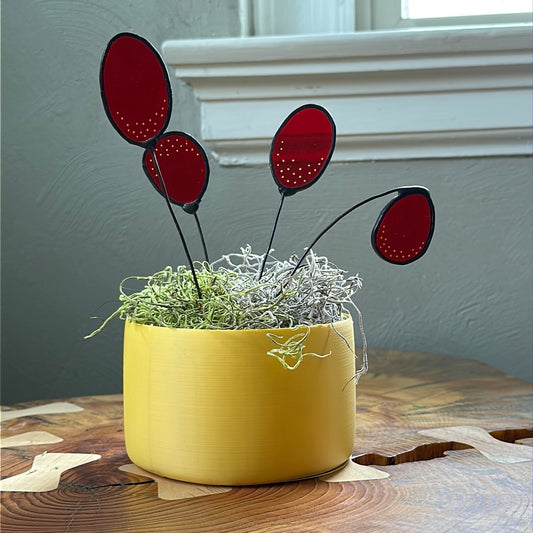 Yellow 3D printed planter with four red glass stems
