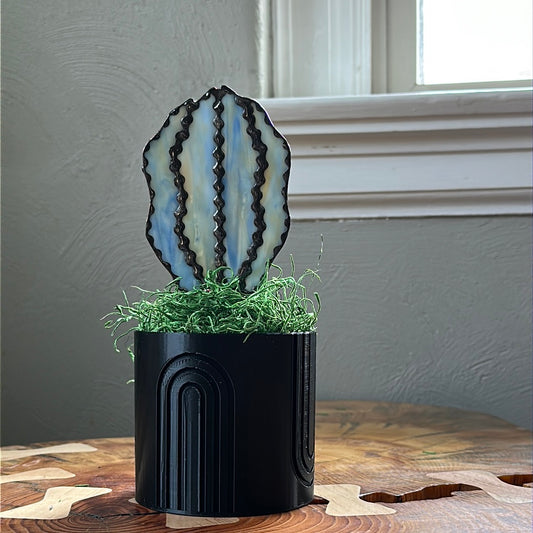 Black 3D planter with blue glass cactus.