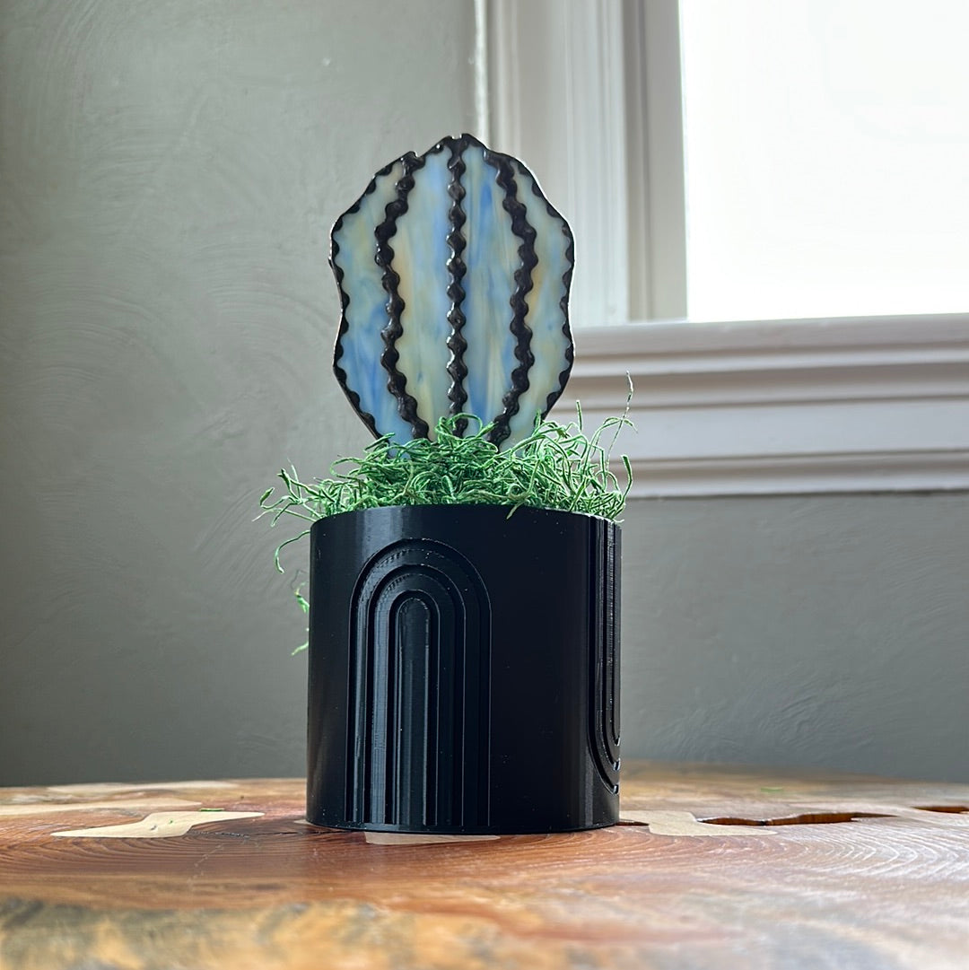Black 3D planter with blue glass cactus.